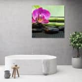 Leinwandbild, Orchidee auf schwarzen Steinen 