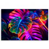 Leinwandbild, Monstera-Blätter in fluoreszierenden Farben 